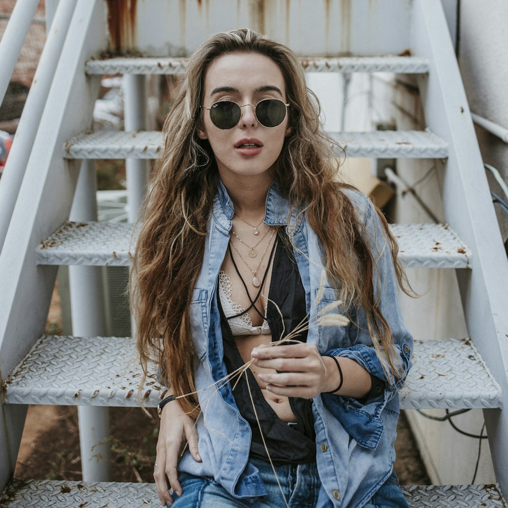 woman wearing black sunglasses on stairs