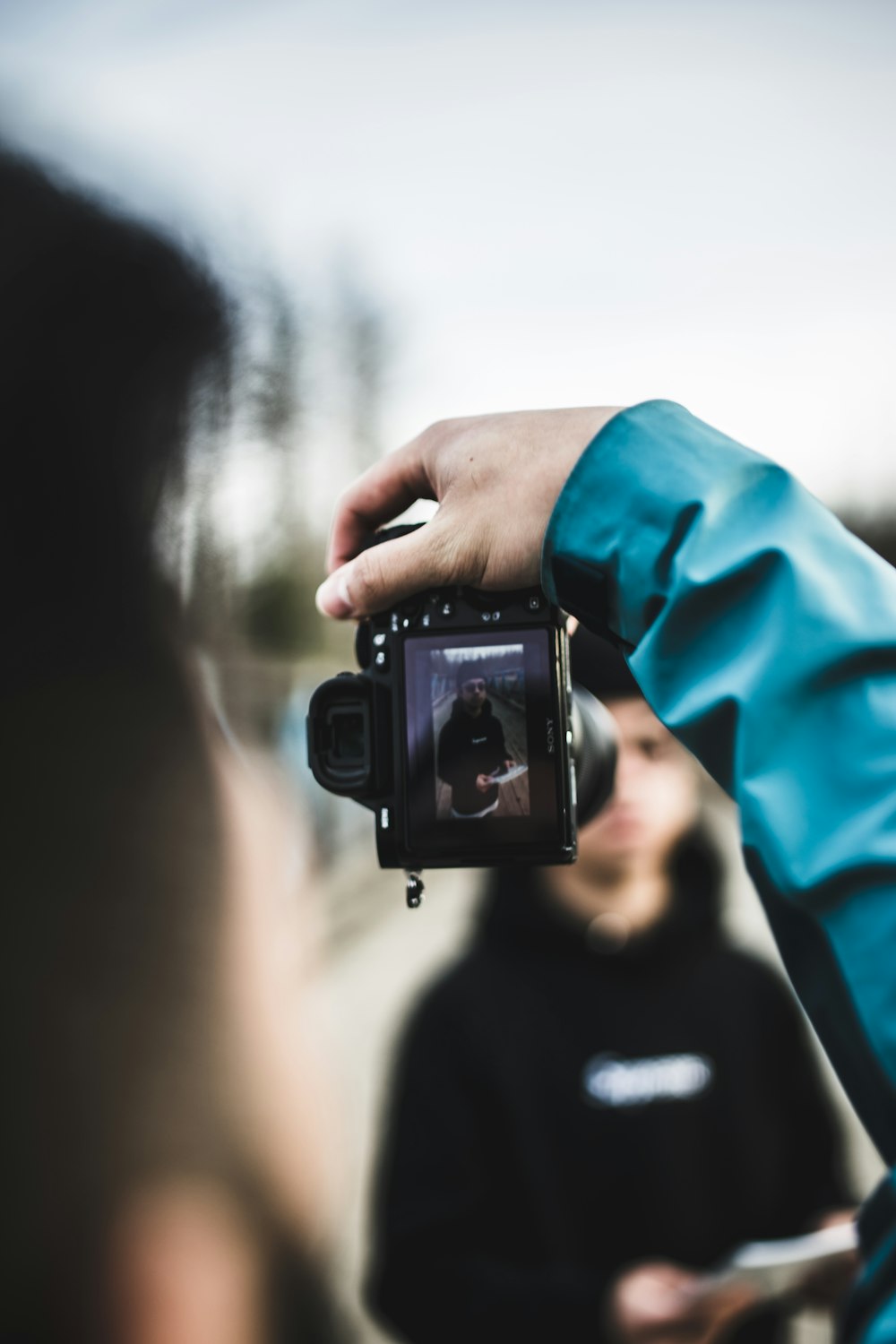 person holding black DSLR camera