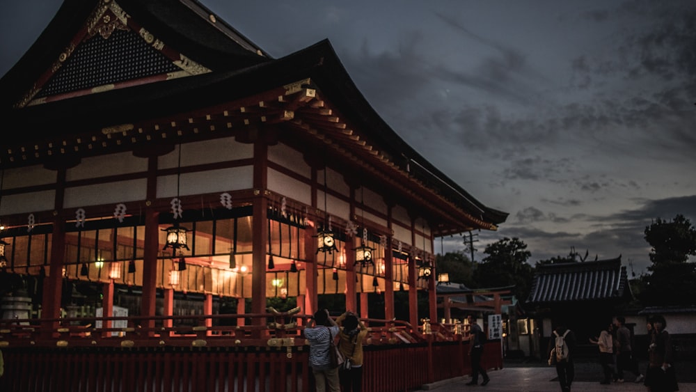 people standing in front of pagoda