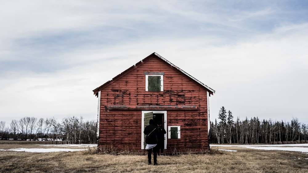 person standing in front of rd barn