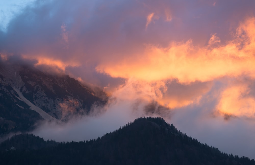 time-lapse photography of mountain under cloudy sky