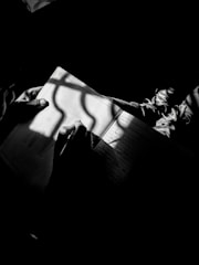 An artist writing a story beside a canvas, illuminated by soft natural light.