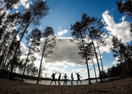 A cheerful group of caregivers and clients enjoying a sunny outdoor activity