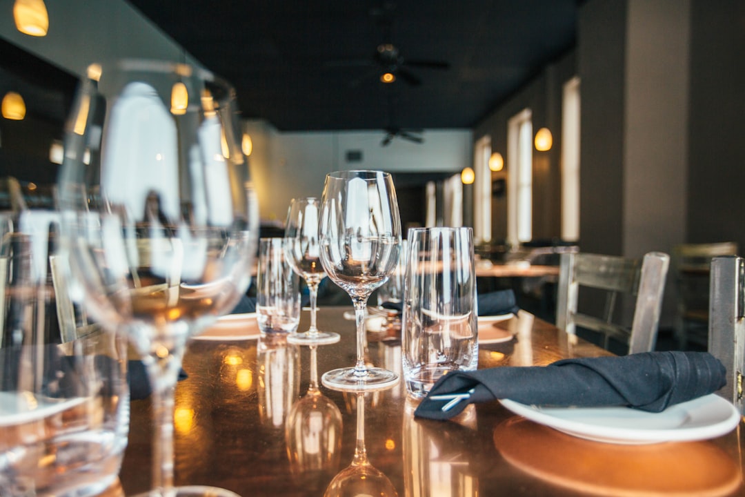 clear wine glasses and drinking glasses on brown wooden table