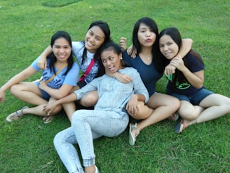 A group portrait of friends sitting closely together, their personalities shining through relaxed poses and genuine smiles.