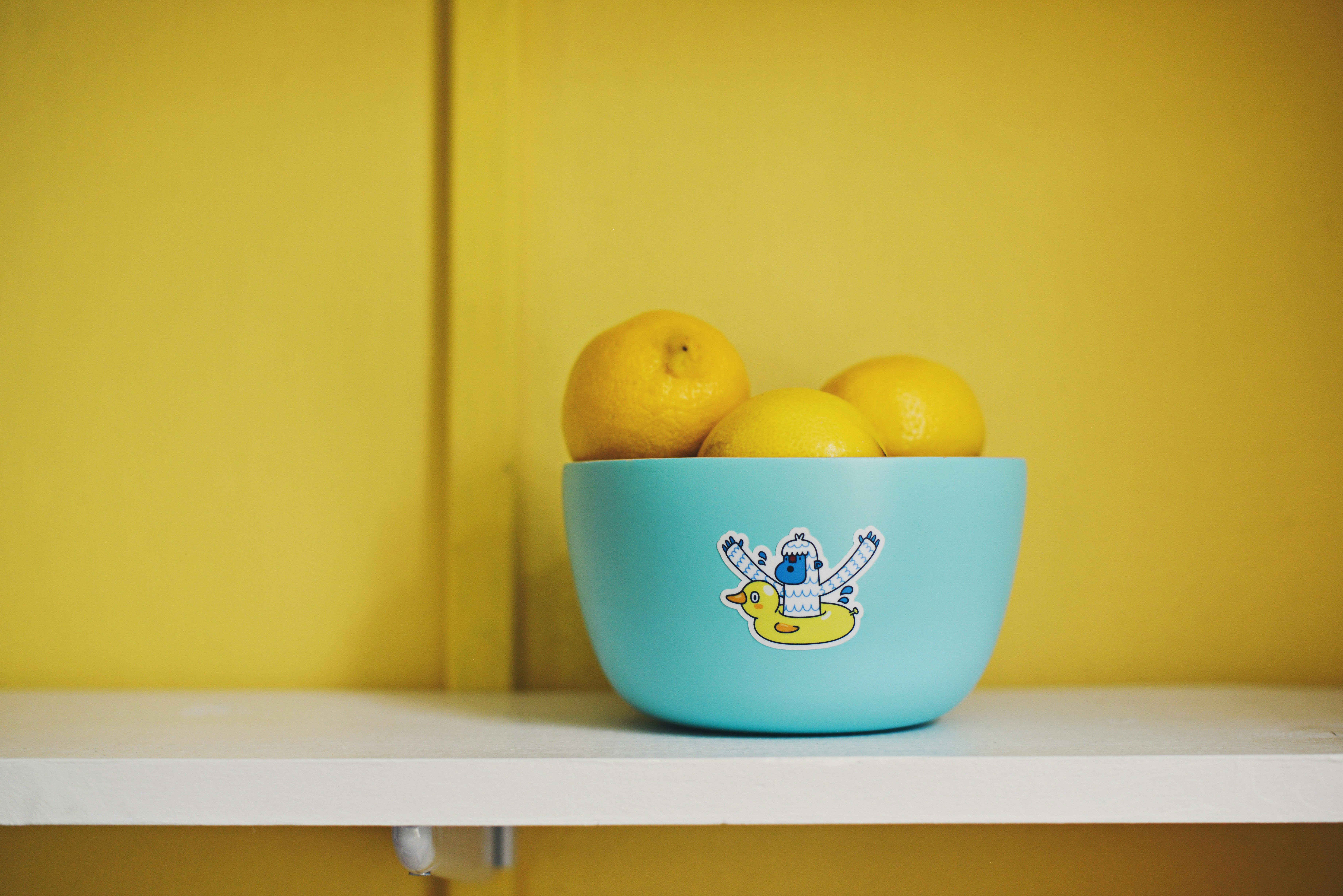 lemon fruits on teal bowl