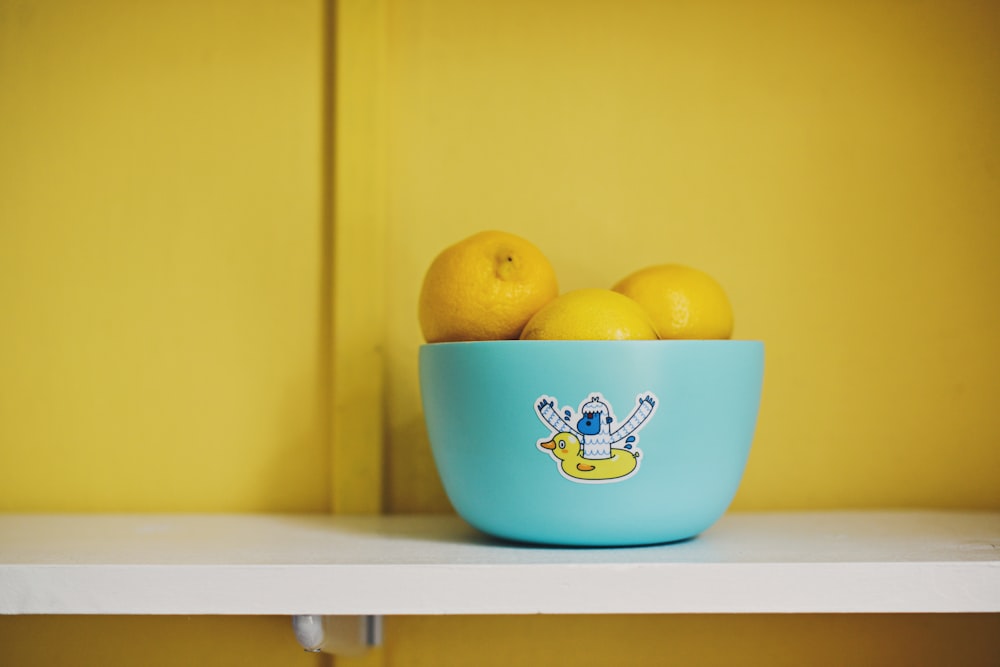 lemon fruits on teal bowl