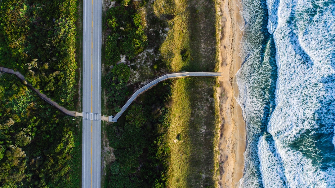 aerial photo of gray roadway near ocean at daytime