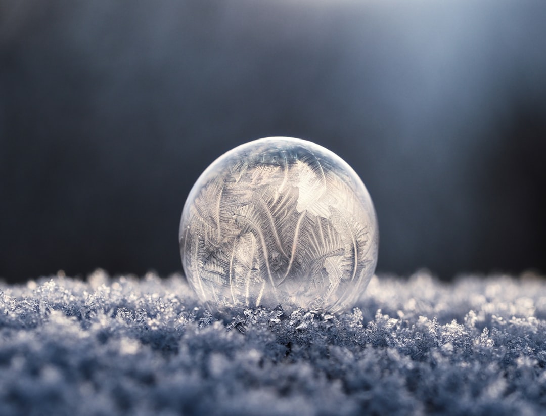focus photo of round clear glass with winter frost inside