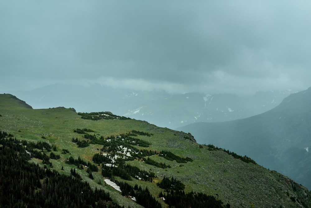 aerial photography of mountain under cloudy sky