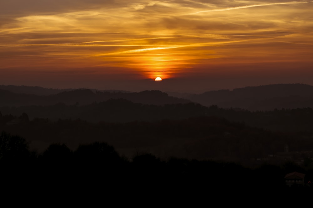 silhouette of mountains on sunset