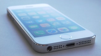 A close-up of a smartphone displaying positive reviews on a screen.