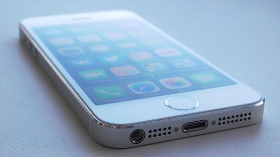 A close-up of a smartphone with a voice assistant interface on the screen.