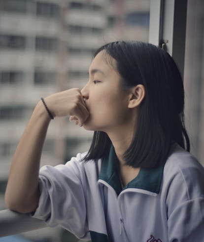 woman looking through window