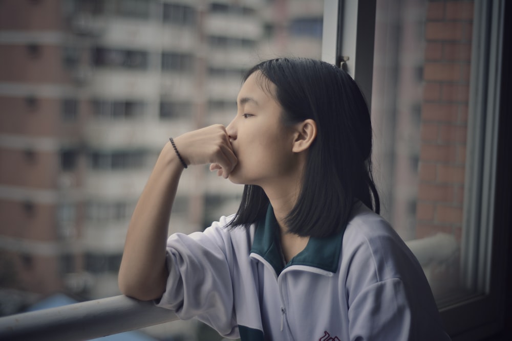 woman looking through window