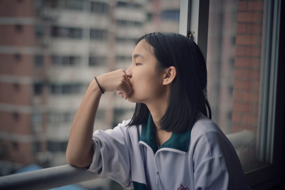 woman looking through window