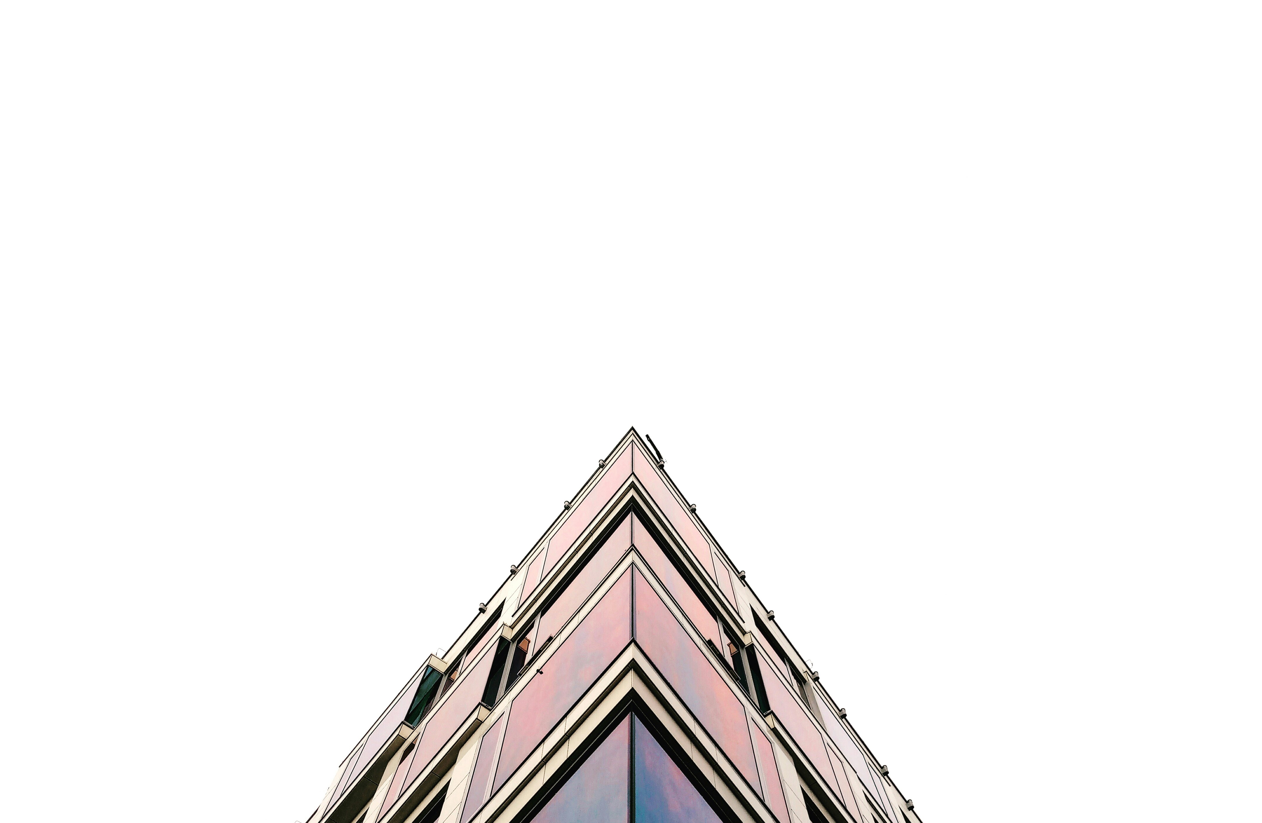 The corner of a building facade in Krakow against a white sky