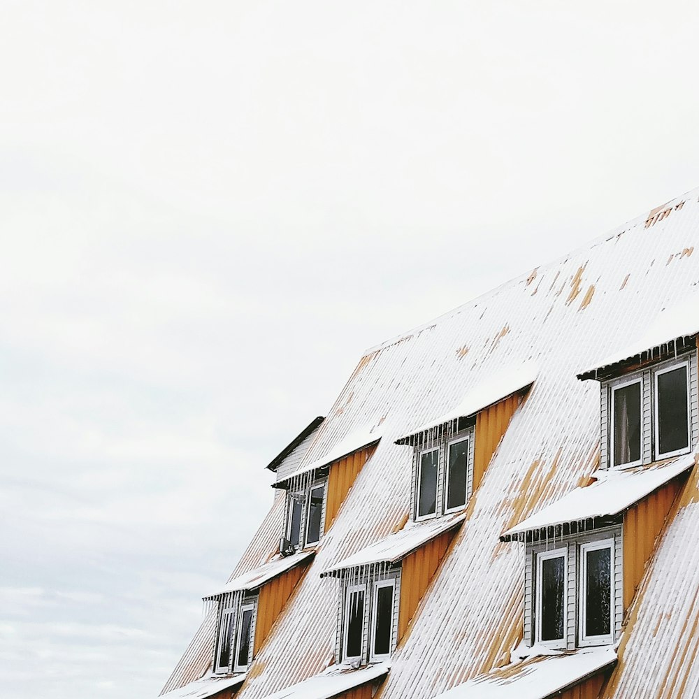 white and brown concrete house under white sky during daytime