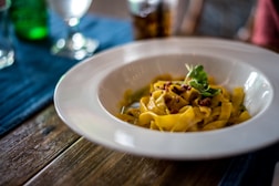 pasta with sauce in white ceramic bowl