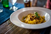 pasta with sauce in white ceramic bowl