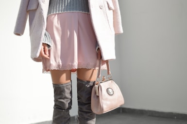 fashion photography,how to photograph fashionable woman in a skirt; women's pink skirt and gray knee boots outfit