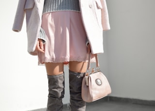 women's pink skirt and gray knee boots outfit