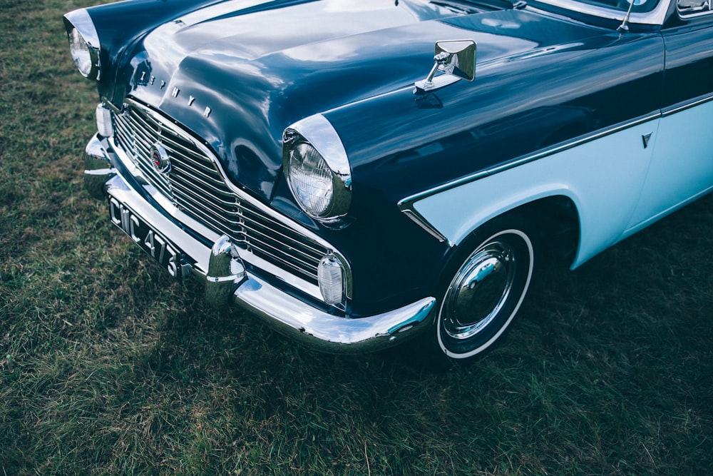 blue and white vehicle on green grass