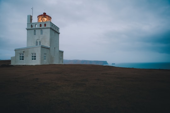 gray concrete building under cloudy sky during daytime in Dyrhólaey Iceland