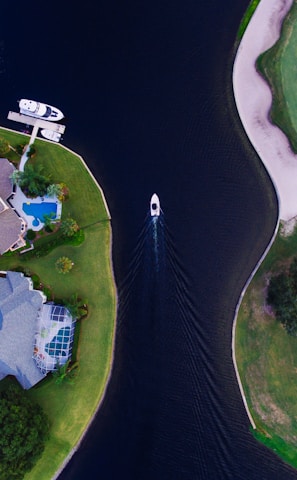 white boat on the ocean near the between the two island aerial photography