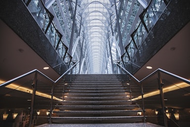 depth with layering for photo composition,how to photograph impressive hallway; gray concrete stairs inside building