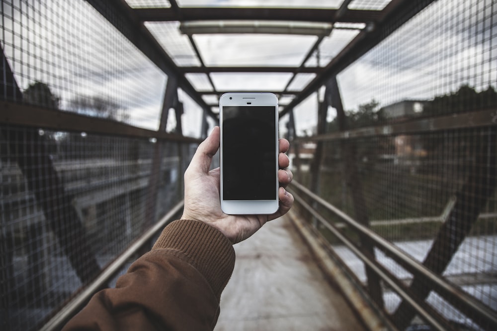 person holding white smartphone