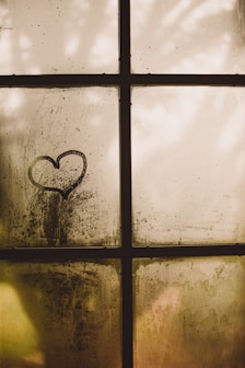 black framed glass window with heart draw