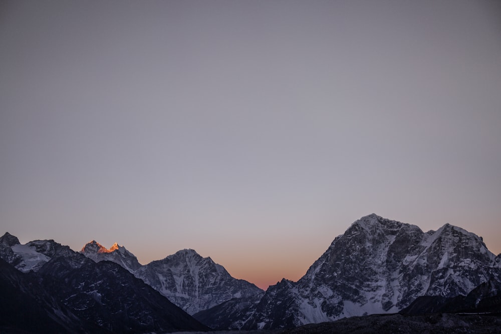 high angle landscape photography of snow covered mountain ranges during golden hour