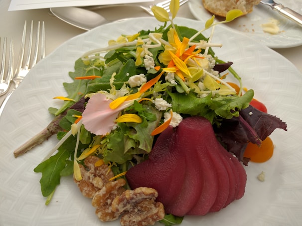 A vibrant beet and goat cheese salad topped with walnuts and fresh arugula.
