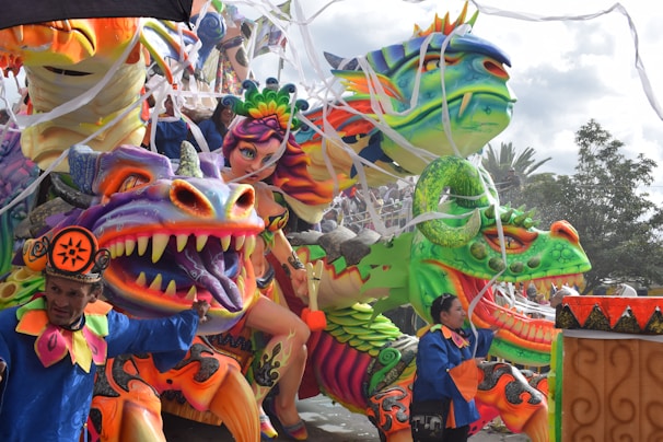 A towering, intricate parade float bursting with vibrant colors and detailed craftsmanship.