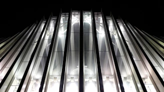 A sleek matte black and gold construction site at dusk, showcasing a modern building framework under dramatic lighting.