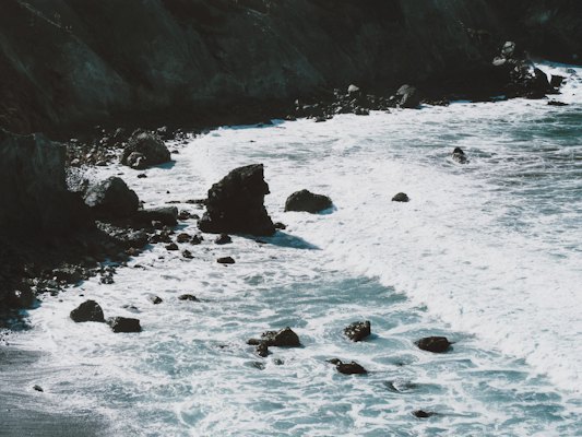 Brown rock formation and body of water at daytime — Big Sur, United States
