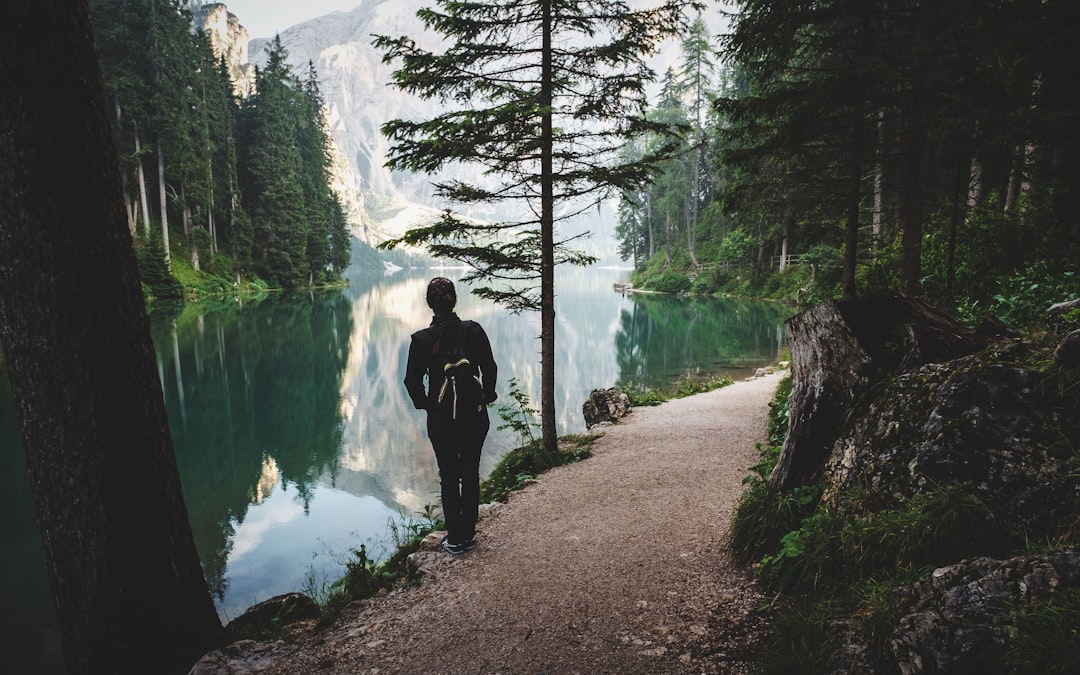 person stands near lake