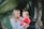 woman holding child while sitting down