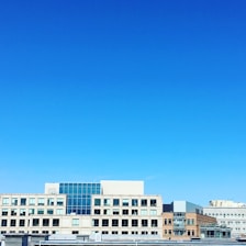Modern urban buildings under a clear sky.