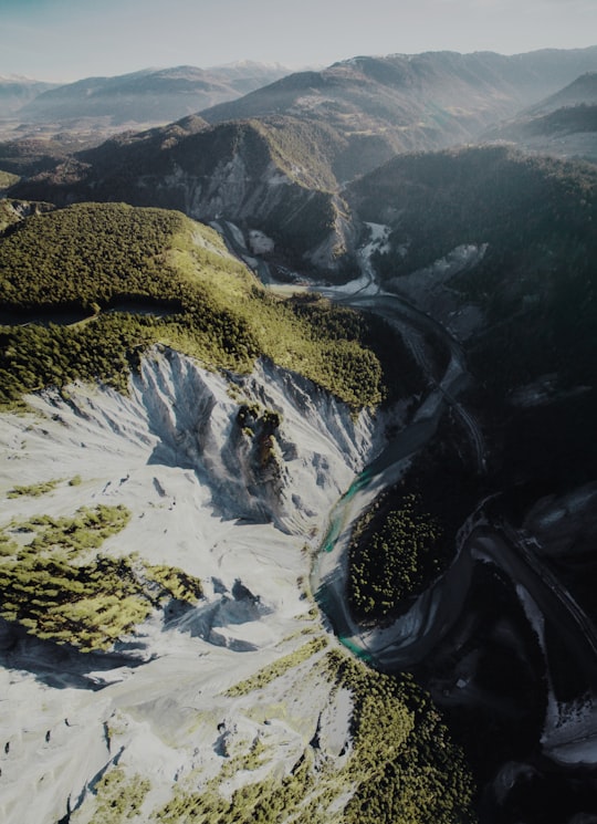 aerial photography of rock mountain and river during daytime in Rheinschlucht Switzerland