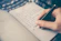 person writing bucket list on book