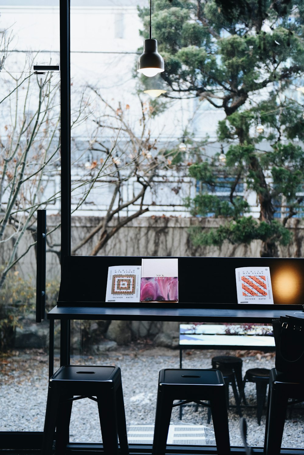 photography of black desk and two black bar stools