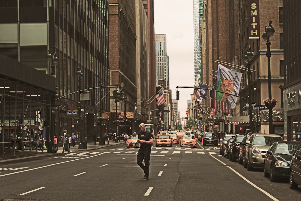 man standing in road during daytime