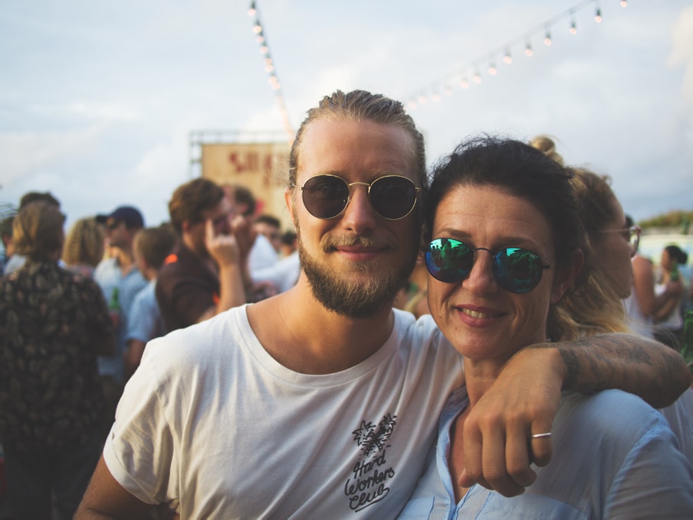 man and woman smiling on focus photography