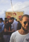 person wearing white crew-neck shirt beside crowd