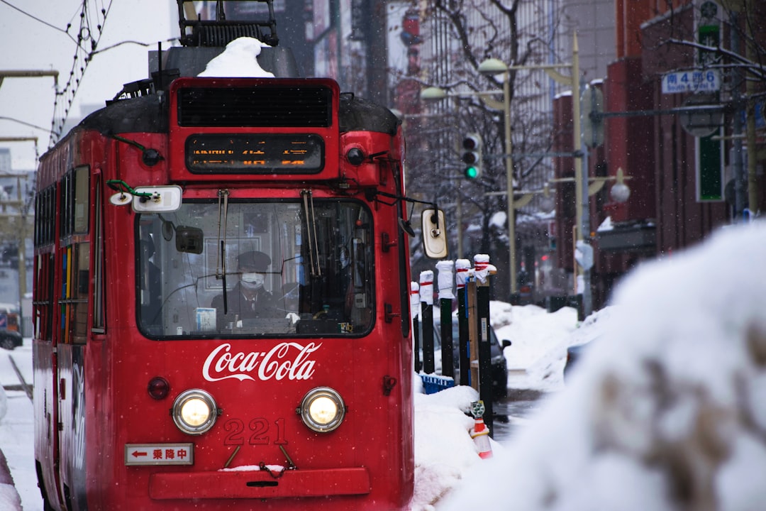 red Coca-Cola tram during snow, Coca Cola trolleybus in Japan