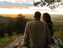 Couple enjoying a sunset view from a scenic spot in South America.
