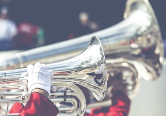 close up photo of person playing horn instrument