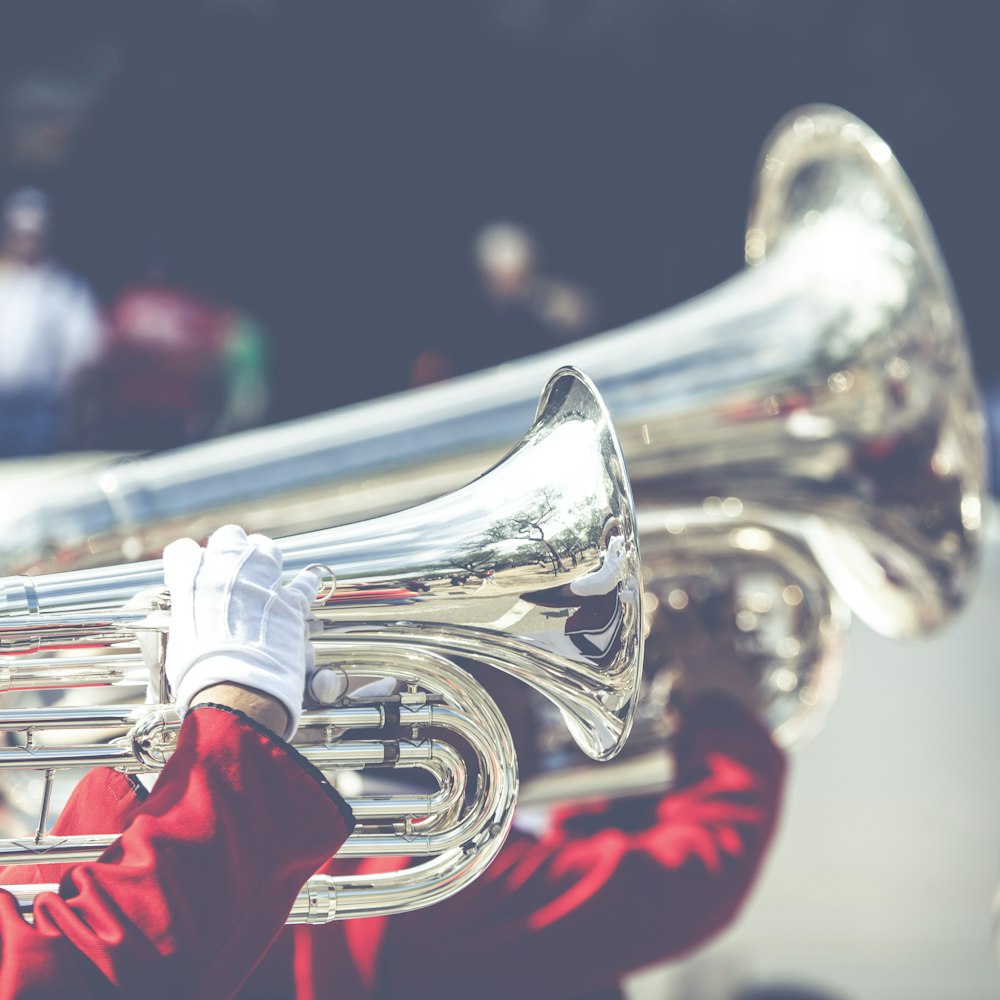 close up photo of person playing horn instrument